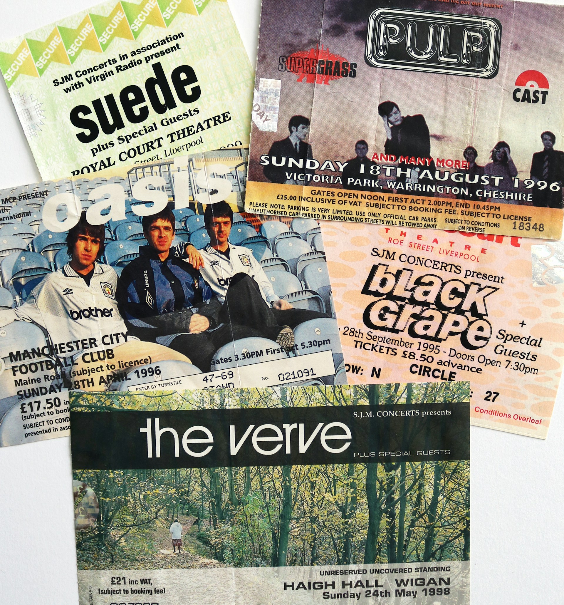 A selection of 90s Britpop gig tickets on top of a table